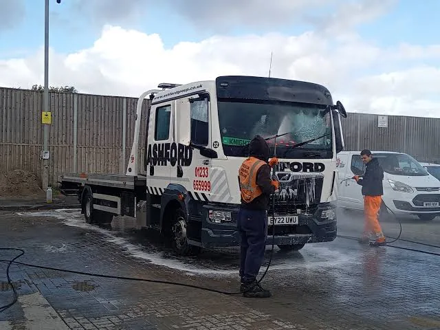 Recovery truck being pressure washed at the truck stop